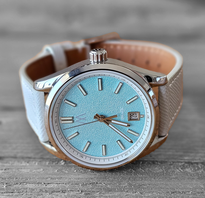 Meshberg 37 Automatic Arctic Sky with icy blue textured dial, light gray leather strap, and polished stainless steel case