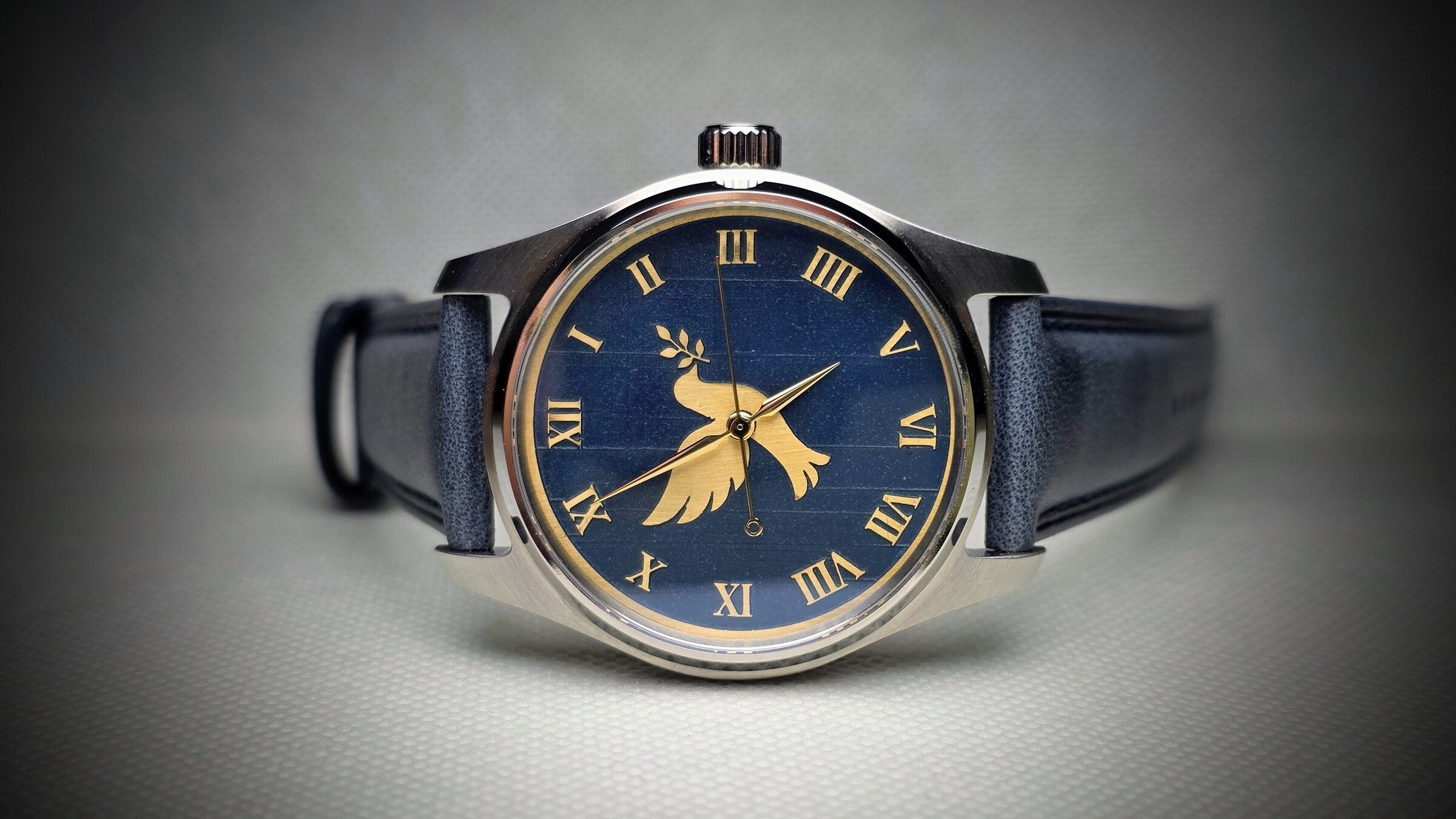 Meshberg 37 Automatic blue dial watch with engraved dove design